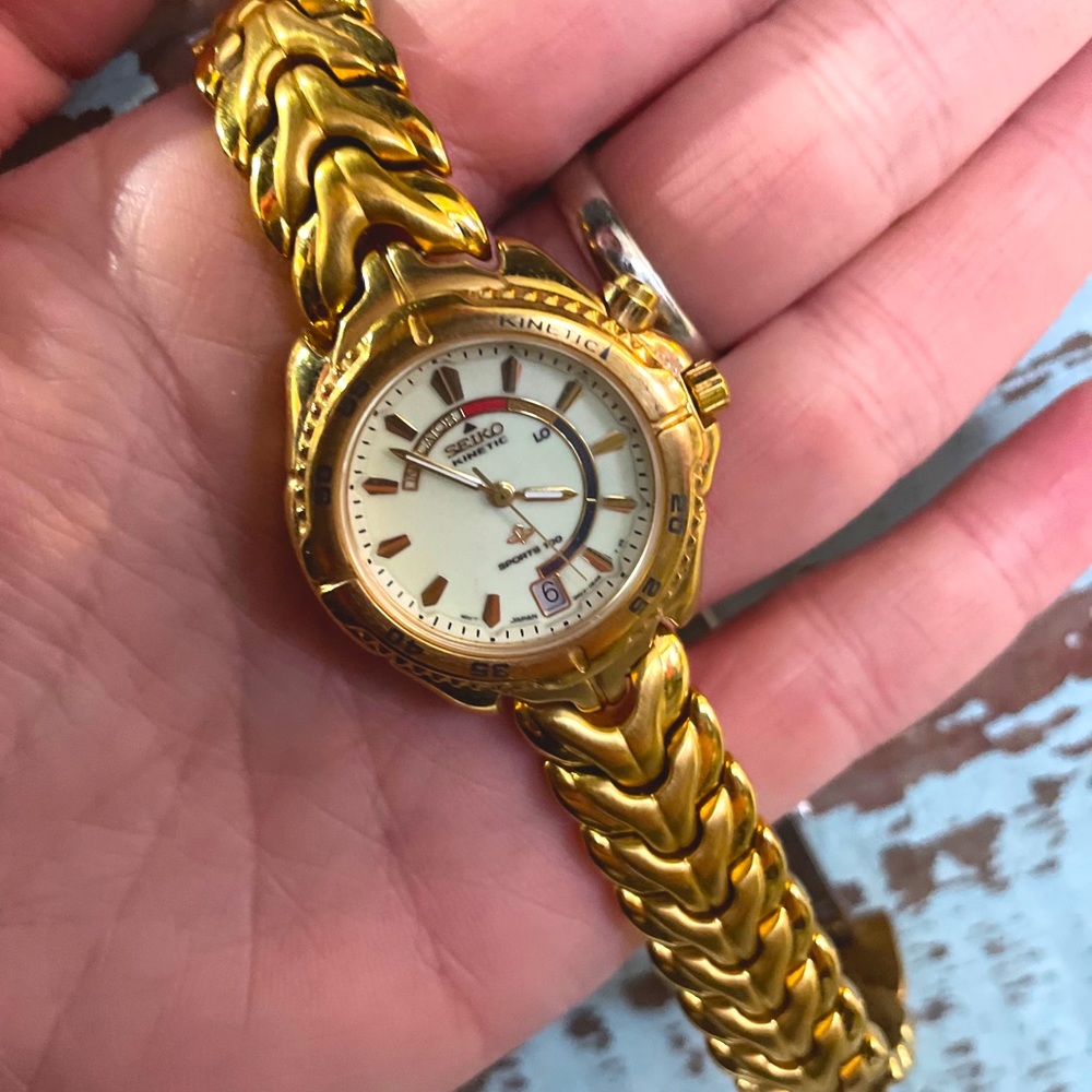 Seiko women’s windward kinetic gold steel watch